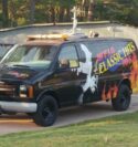 WFJA/WWGP Radio van. A black van featuring WFJA's logo, a guitar being strummed, and flames.